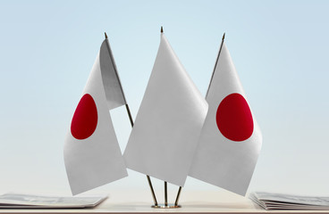 Two flags of Japan with a white flag in the middle