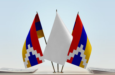 Two flags of Nagorno-Karabakh with a white flag in the middle