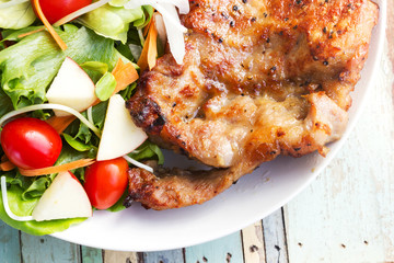 Black pepper pork chop steak with salad.