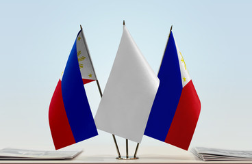 Two flags of Philippines with a white flag in the middle