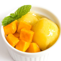 Mango icecream in a white bowl on white background. Tropical fruite. Sweet dessert.