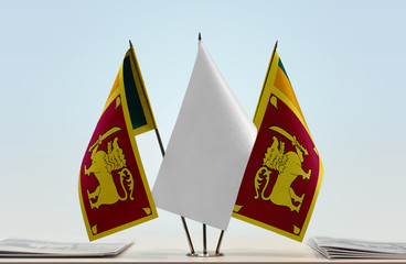 Two flags of Sri Lanka with a white flag in the middle