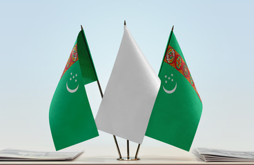 Two flags of Turkmenistan with a white flag in the middle