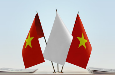 Two flags of Vietnam with a white flag in the middle