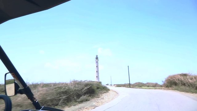 California Lighthouse on blue sky background. North coast. Off-road Aruba. Amazing stone desert landscape. Aruba coastline.