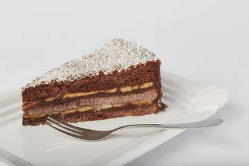 Chocolate and banana birthday cake on the white background