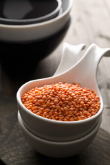 Raw red, dried  lentils in bowl on table