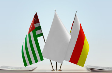 Flags of Abkhazia and South Ossetia with a white flag in the middle