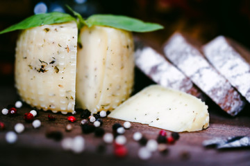 Rustic cheese with herbs, rye bread and peppercorn