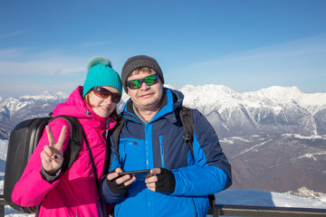young couple on background of  snowy mountain