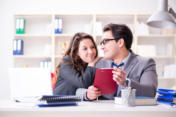 Happy couple working in the same office