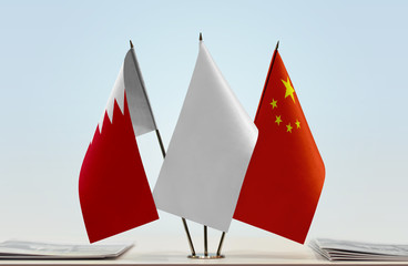 Flags of Bahrain and China with a white flag in the middle