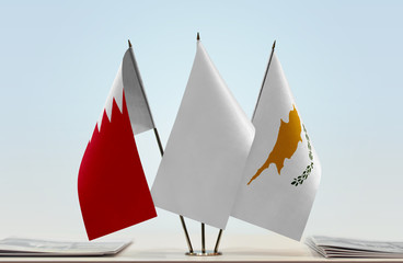 Flags of Bahrain and Cyprus with a white flag in the middle