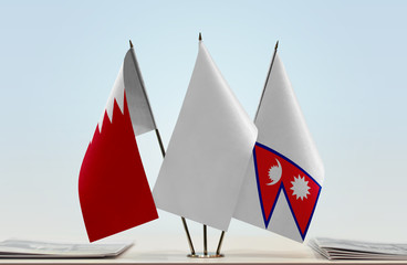 Flags of Bahrain and Nepal with a white flag in the middle