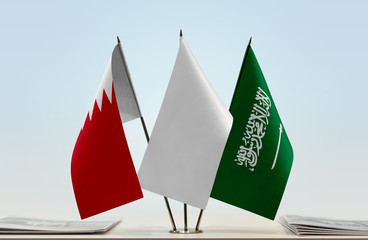 Flags of Bahrain and Saudi Arabia with a white flag in the middle