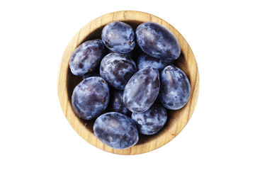 fresh plum in a wooden plate