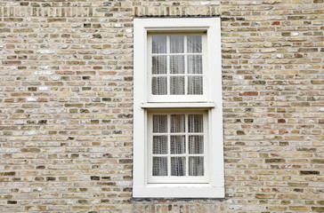 Fototapeta na wymiar white wooden window on brick wall