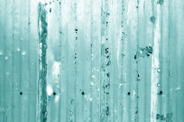 Grungy metal wall in cyan tone.