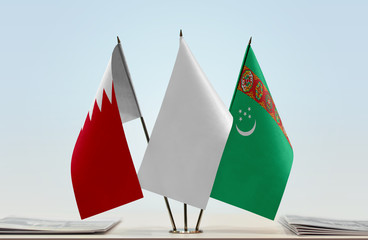 Flags of Bahrain and Turkmenistan with a white flag in the middle