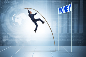 Businessman jumping over money in business concept