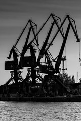 Gdansk shipyard, Poland. Retro style black and white. Cranes, old shipyard buildings, rusty...