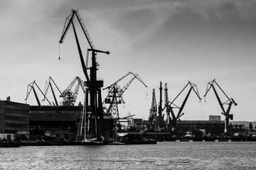 Gdansk shipyard, Poland. Retro style black and white. Cranes, old shipyard buildings, rusty...