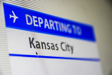 Computer screen close-up of status of flight departing to Kansas City, Missouri, USA