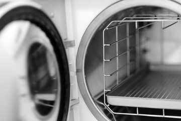 The open door of a medical autoclave, apparatus for sterilizing surgical instruments under pressure heating