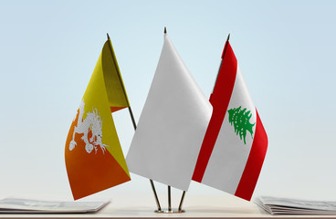 Flags of Bhutan and Lebanon with a white flag in the middle