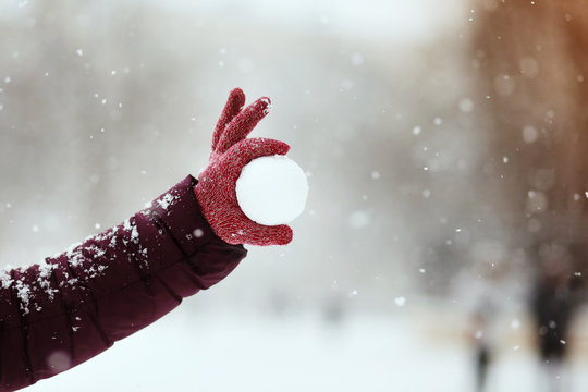 Close up of woman holding the snowball in hands, winter concept with copy space
