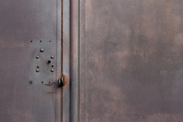 Dark grey background texture metallic garage door gate with red infernal color  and copy space