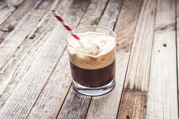 Morning espresso with whipped cream and strawberry