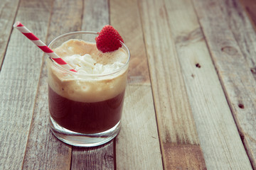 Morning espresso with whipped cream and strawberry