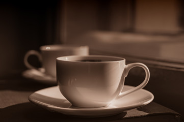 cup of coffee on the window sill.