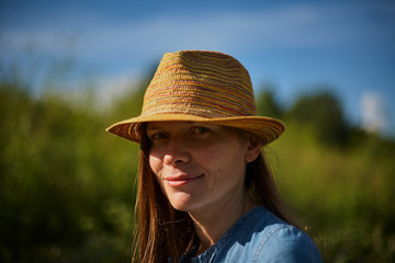 Smiling Woman With a Hat Looking at the Camera Direction.