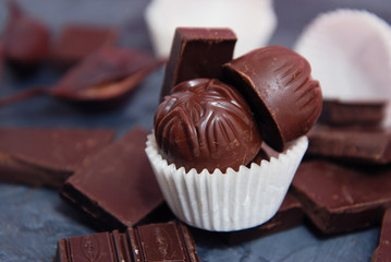 Chocolate Truffle Pieces and and Chocolate Bar Dessert. Dark Vintage Board. Sweet Dessert.