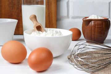 eggs milk flour and various ingredients for cooking in rustic style with copy space