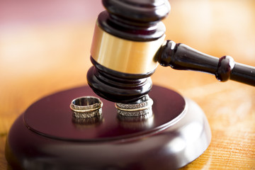 Family law concept. Gavel and rings 