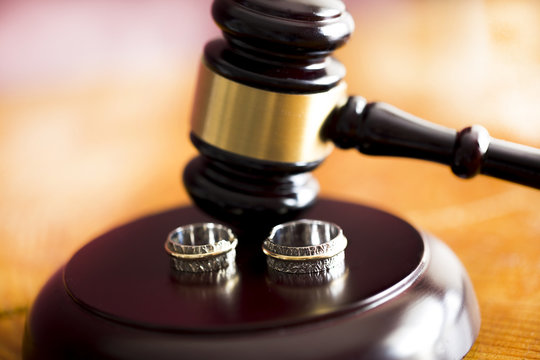 Family law concept. Gavel and rings 