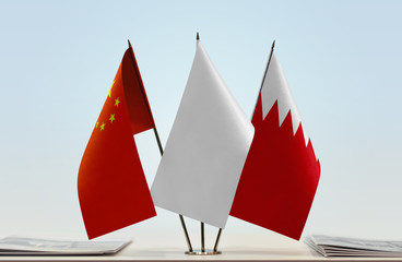 Flags of China and Bahrain with a white flag in the middle