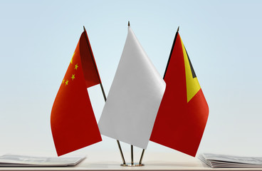 Flags of China and East Timor with a white flag in the middle