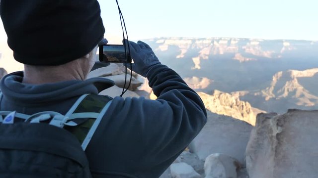 Traveller taking panoramic shots on Grand Canyon