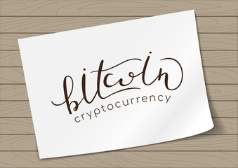 Bitcoin Cryptocurrency - Hand Drawn Lettering on A4 Paper on Wood Background. Vector Illustration Quote. Handwritten Inscription Phrase for T-shirt Print, Sale, Banner, Logotype, Logo.