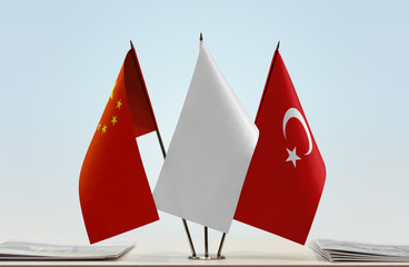 Flags of China and Turkey with a white flag in the middle