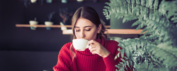 Girl in a cafe drinking tea
