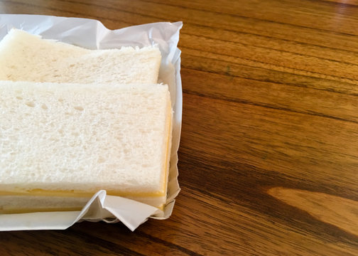 Two Cheese sandwich typical from Argentina on wooden table with copy space