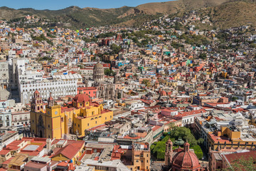 A UNESCO Heritage Site-Guanajuato City, Mexico, from up on a hill, with a view of the Basilica, Guanajuato University, many other buildings and colorful houses - 190929000