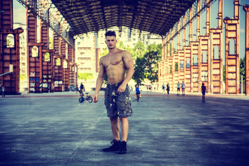 Handsome Muscular Shirtless Hunk Man Outdoor in City Setting. Showing Healthy Body While Looking at Camera