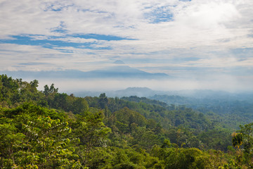 Fototapeta na wymiar View to Gunung Merapi, Merbabu, Borobudur from Punthuk Setumbu viewpoint near Yogyakarta city, Central Java, Indonesia