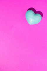 Naklejka na ściany i meble Turquoise heart shape over purple color table. Valentine Day concept.